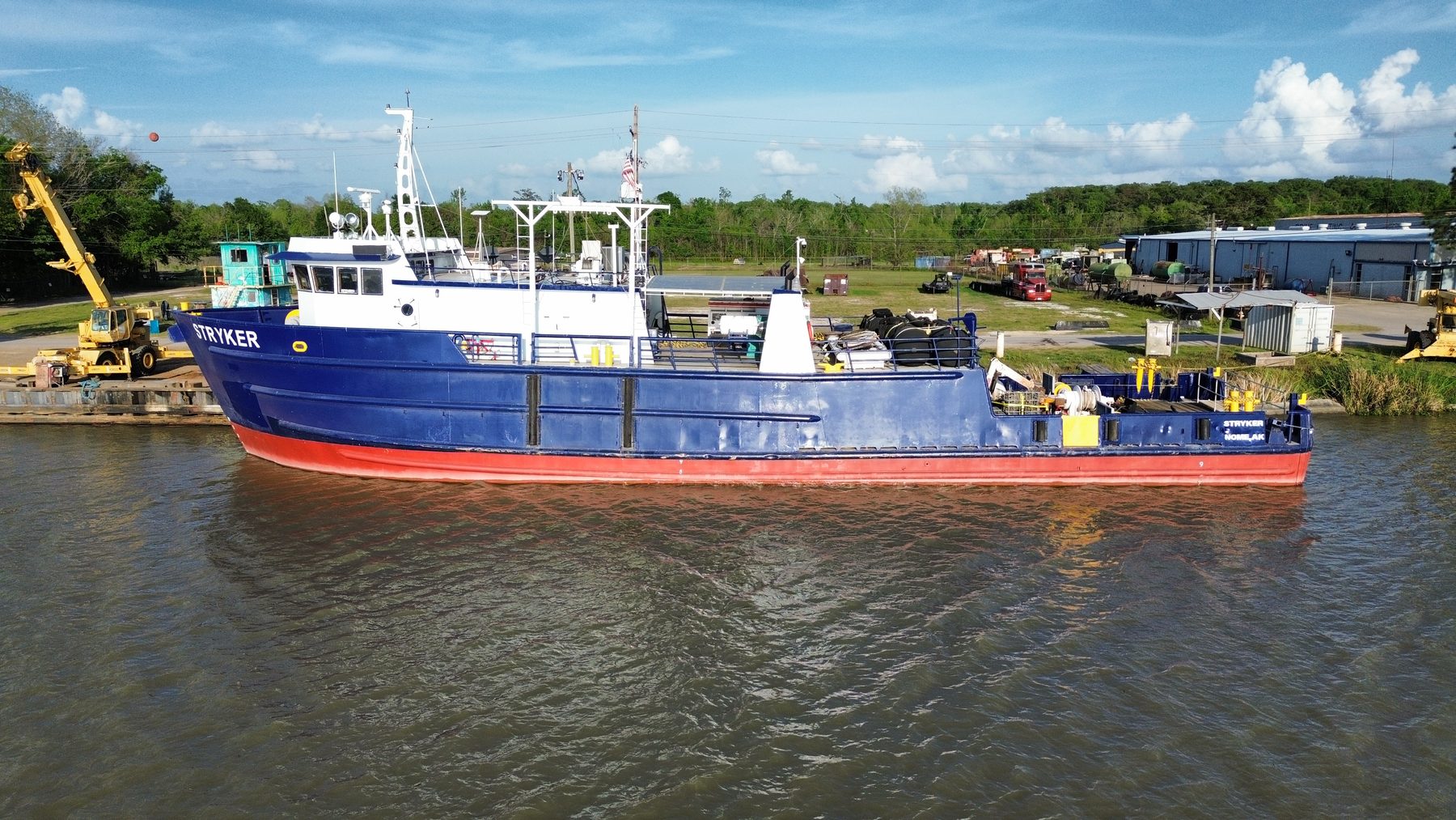 Aerial broadside view of the Stryker afloat on a river