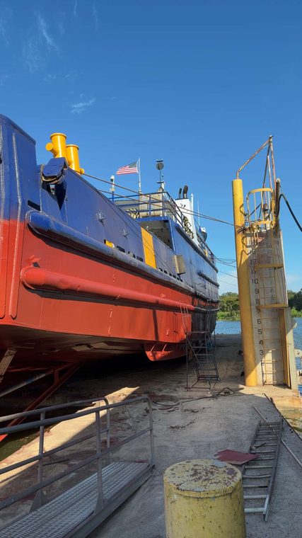 The Stryker in drydock viewed from the quarter, hull and bulwarks in red and blue