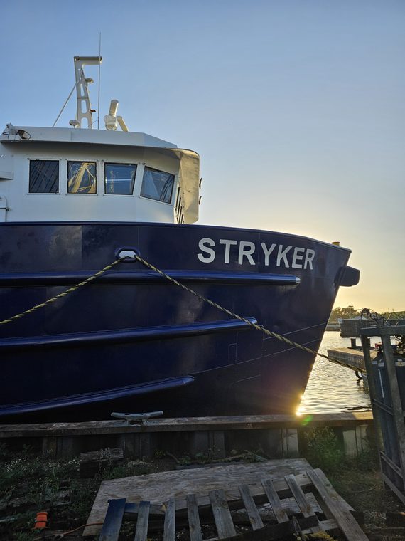 The Stryker bow at sunset with the sun low behind the hull