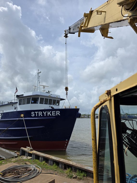 The Stryker afloat, seen past the cab of a yard crane