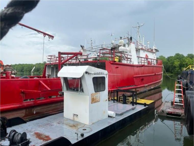 The Stryker in a shipyard with her red hull visible